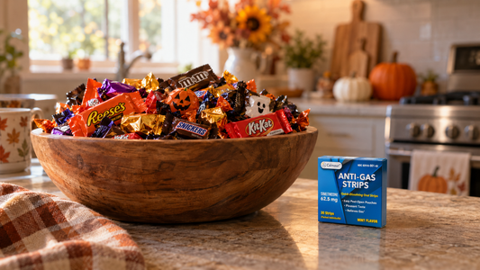 Bowl of Halloween candy next to a pack of Calmour Anti-Gas Oral Strips
