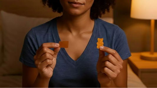 A person holding both a melatonin strip and a gummy before bed