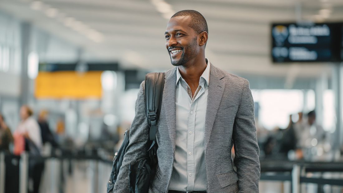 Traveler confidently going through TSA airport security with travel-friendly vitamin supplements