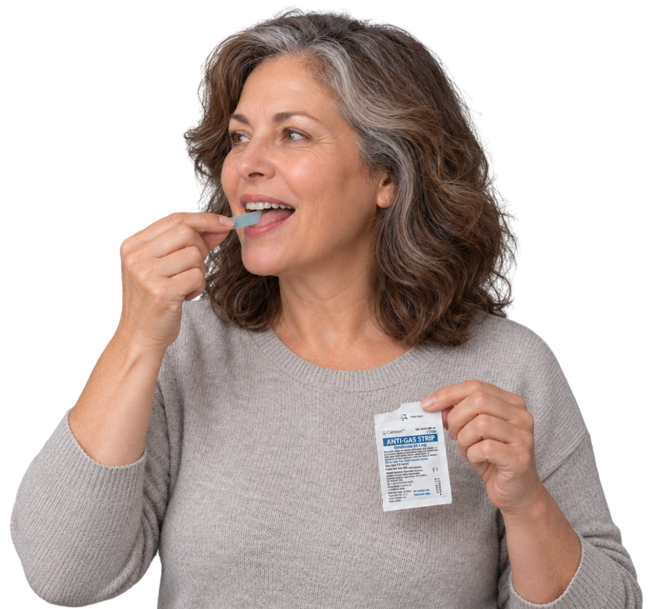 Woman placing a Calmour anti-gas strip on her tongue, holding an opened sachet