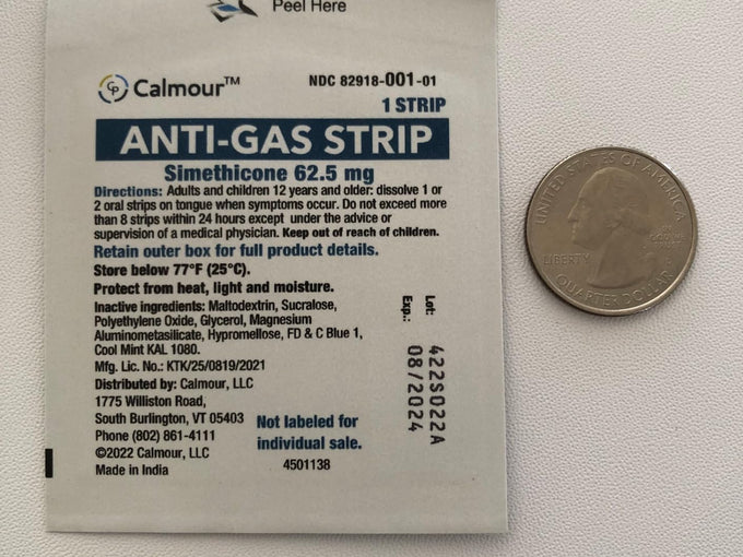 A Calmour sachet beside a US quarter