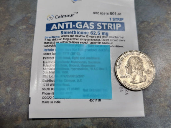 An opened sachet next to a quarter on a worktop