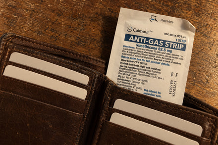 A Calmour sachet tucked into the note compartment of a worn leather wallet